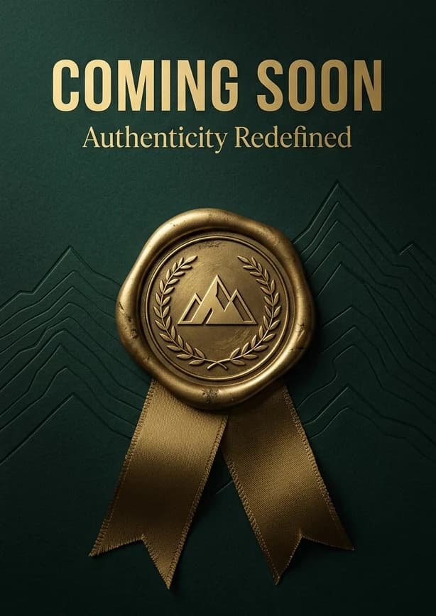 A deep-green card stamped with a gold wax seal of the mountains, with gold ribbons and the words Coming soon, Authenticity redefined